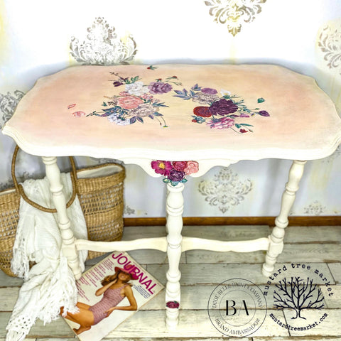 Sun Kissed Silk All-In-One paint is perfect for painting kitchen cabinets, bathroom cabinets and painting furniture.
console table painted in Sun Kissed Silk All-In-One paint  with the top blended with a pink and it has the Flower Child - Transfer on the top of the table. Staged with a woven bag and magazine under the table.