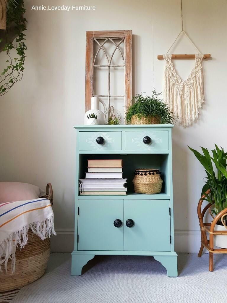 Tide Pool Silk All-In-One paint is perfect for painting kitchen cabinets, bathroom cabinets and painting furniture.  A blue chalk painted nightstand with black knobs and a white stenciled design on the drawers.