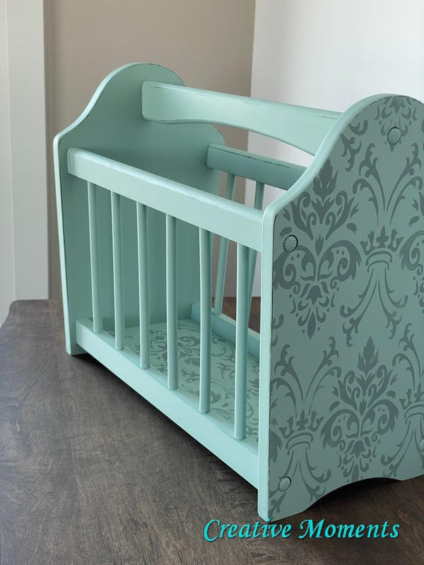 Tide Pool Silk All-In-One paint is perfect for painting kitchen cabinets, bathroom cabinets and painting furniture.  A blue chalk painted magazine floor rack with an ornate design stenciled on the end and bottom in a silver chalk painted color.