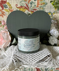 Bluish gray painted wooden heart with a jar of Smoky Mountains in front of it. Staged with crocheted lace and faux flowers.