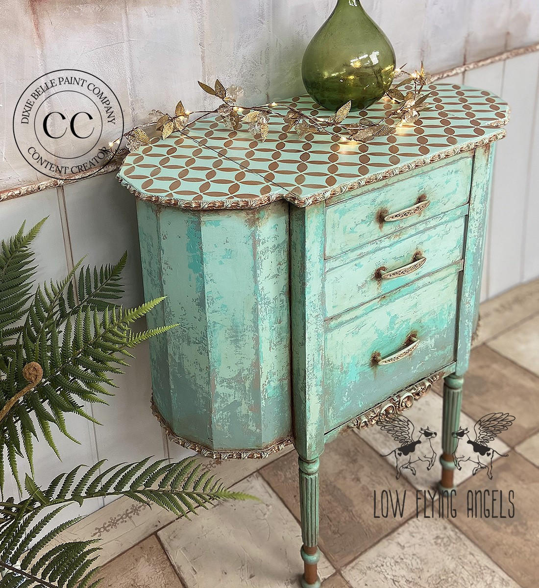 Terra Clay Paint Blue Agave Terra Clay Paint provides endless possibilities for your imagination and can be used on wood, canvas, tile, fabric and more! Antique refurbished two legged Cabinet painted with Blue Agave Terra Clay Paint with accented bronze top and gold hardware. Stages with gold leaves across the top next to a green glass transparent vase.