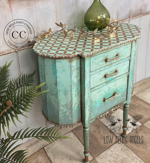 Terra Clay Paint Blue Agave Terra Clay Paint provides endless possibilities for your imagination and can be used on wood, canvas, tile, fabric and more! Antique refurbished two legged Cabinet painted with Blue Agave Terra Clay Paint with accented bronze top and gold hardware. Stages with gold leaves across the top next to a green glass transparent vase.