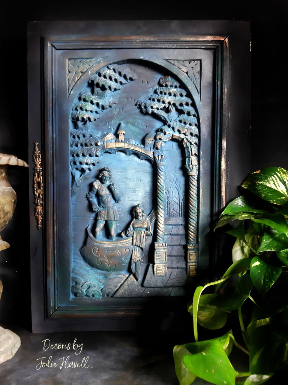 Blue Moon Terra Clay Paint provides endless possibilities for your imagination and can be used on wood, canvas, tile, fabric and more!
A 3D  black picture frame with Blue Moon Terra Clay Paint to accent the inside of art with gold accents on the high points.Staged with a black background and greenery.