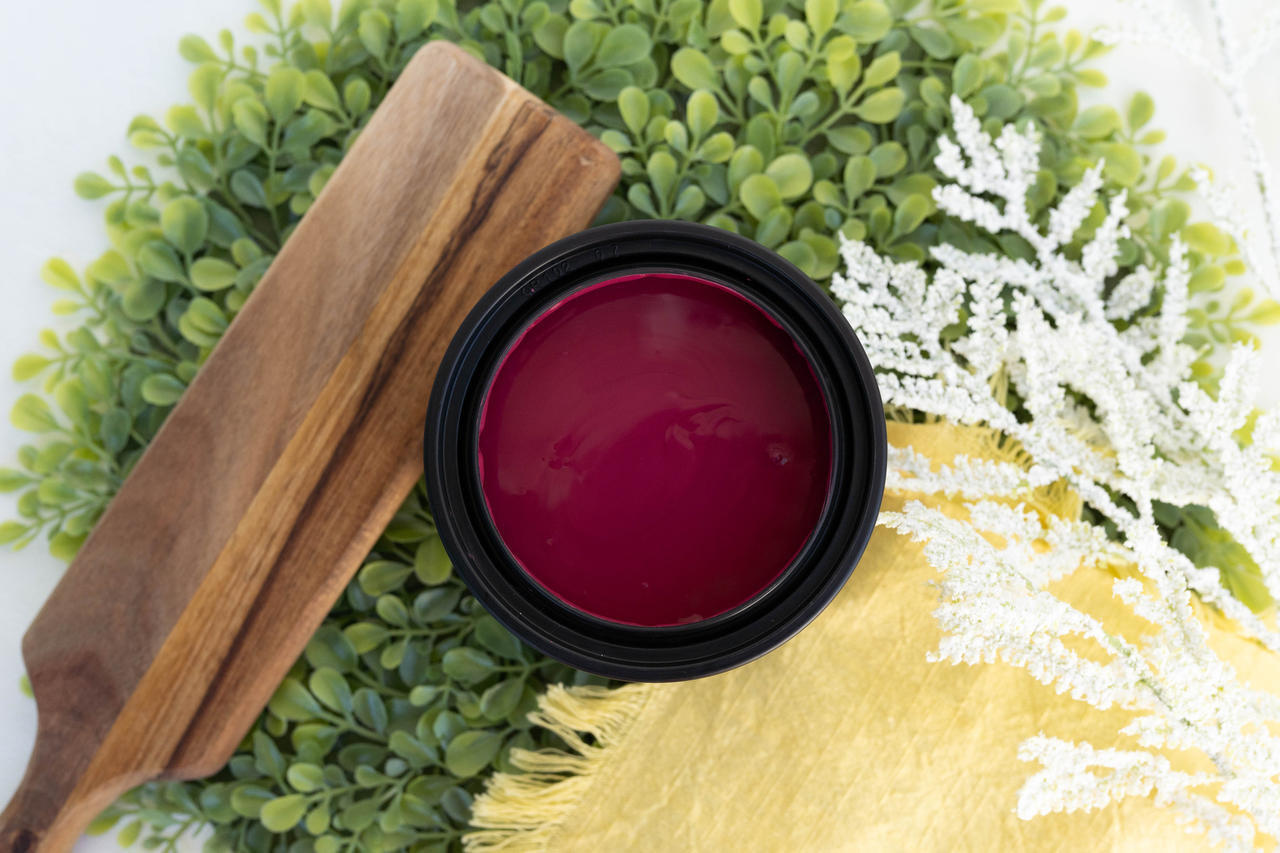 Bougainvillea Terra Clay Paint provides endless possibilities for your imagination and can be used on wood, canvas, tile, fabric and more!
Opened container of Bougainvillea Terra Clay Paint staged with white pine branches, Greenery, slim wooden tray with a yellow linen.