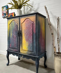 Bougainvillea Terra Clay Paint provides endless possibilities for your imagination and can be used on wood, canvas, tile, fabric and more! 
Drink cabinet painted in Bougainvillea Terra Clay Paint as well as a yellow,hints of orange and overall a charcoal. Staged with drift wood inside a vase.
