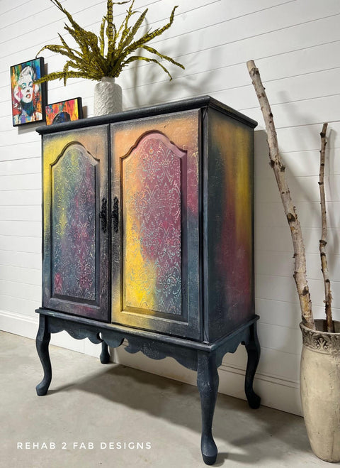 Bougainvillea Terra Clay Paint provides endless possibilities for your imagination and can be used on wood, canvas, tile, fabric and more! 
Drink cabinet painted in Bougainvillea Terra Clay Paint as well as a yellow,hints of orange and overall a charcoal. Staged with drift wood inside a vase.