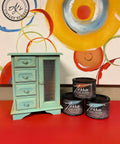 Cerulean Blue Terra Clay Paint provides endless possibilities for your imagination and can be used on wood, canvas, tile, fabric and more!
Jewelry box painted in Cerulean Blue Terra Clay Paint staged with containers of Cerulean Blue, Marigold, and Lani's Lagoon Terra Clay Paint Stacked ontop of eachother