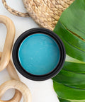 Cerulean Blue Terra Clay Paint provides endless possibilities for your imagination and can be used on wood, canvas, tile, fabric and more!
Opened container of Cerulean Blue Terra Clay Paint. Staged with wooden links, Greenery and a woven tray.