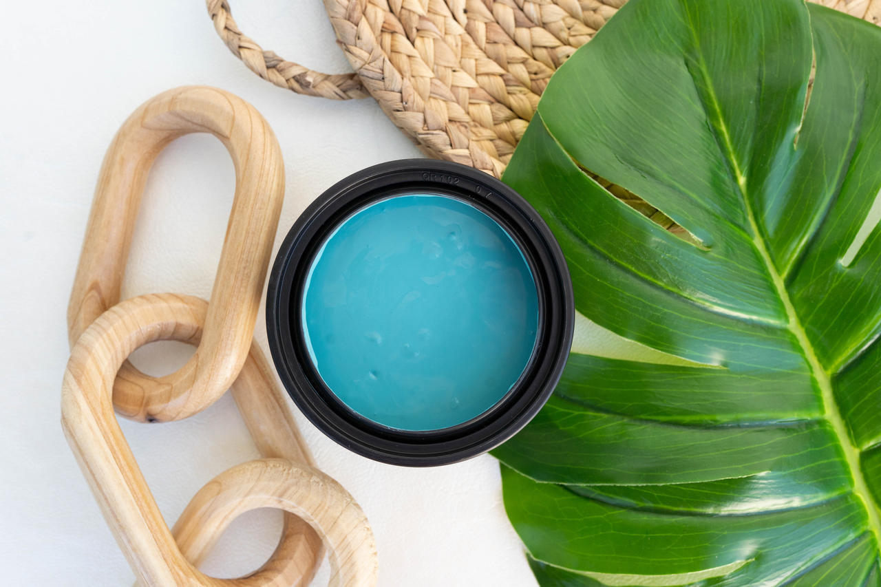 Cerulean Blue Terra Clay Paint provides endless possibilities for your imagination and can be used on wood, canvas, tile, fabric and more!
Opened container of Cerulean Blue Terra Clay Paint. Staged with wooden links, Greenery and a woven tray.