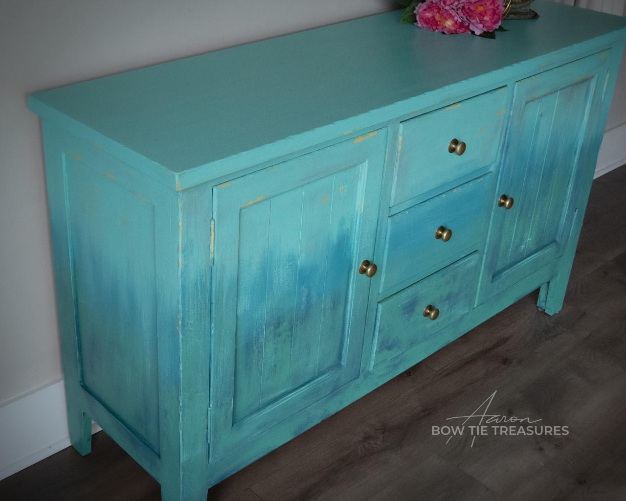 Cerulean Blue Terra Clay Paint provides endless possibilities for your imagination and can be used on wood, canvas, tile, fabric and more!
Entertainment center cabinet painted in Cerulean Blue Terra Clay Paint as well as Blue Agave, Lani Lagoons, Blue Moon and Malachite used in layers and a gradient between the colors. .