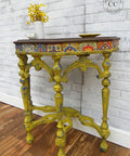 Terra Clay Paint Daffodil Terra Clay Paint provides endless possibilities for your imagination and can be used on wood, canvas, tile, fabric and more! A half moon hallway table that has a decoupage on the top of the drawer and wrapped around the top sides. The table legs are painted in daffodil and is distressed with blue to tie in the decoupage paper.