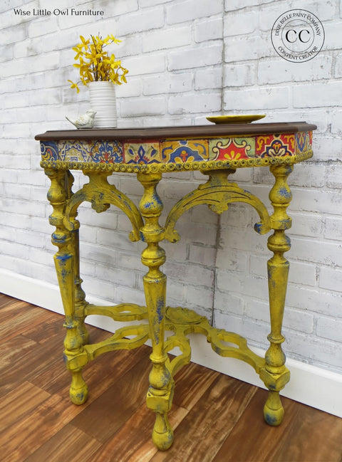 Terra Clay Paint Daffodil Terra Clay Paint provides endless possibilities for your imagination and can be used on wood, canvas, tile, fabric and more! A half moon hallway table that has a decoupage on the top of the drawer and wrapped around the top sides. The table legs are painted in daffodil and is distressed with blue to tie in the decoupage paper.