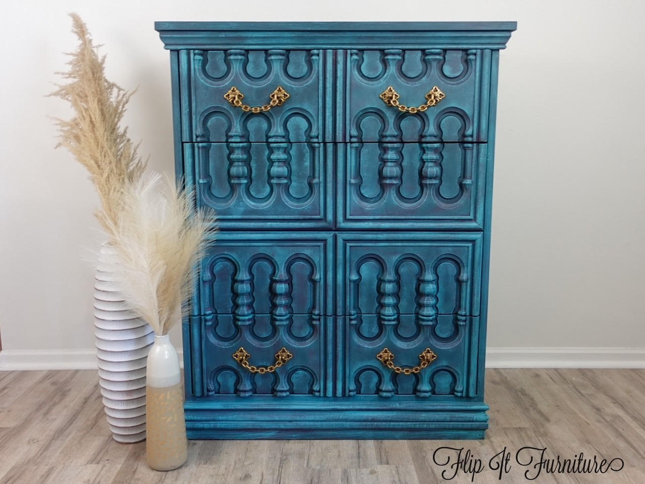 Elderberry Terra Clay Paint provides endless possibilities for your imagination and can be used on wood, canvas, tile, fabric and more! Blue chalk painted furniture with golden pulls. Staged with two white vases containing large feathers.