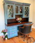 London Blue Terra Clay Paint provides endless possibilities for your imagination and can be used on wood, canvas, tile, fabric and more! 
Office desk with hutch painted in London Blue Terra Clay Paint with the natural wood on the top of the desk. Staged with a Desk chair and vases full of flower on the side and on the desk.