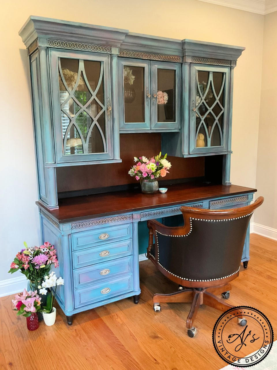 London Blue Terra Clay Paint provides endless possibilities for your imagination and can be used on wood, canvas, tile, fabric and more! 
Office desk with hutch painted in London Blue Terra Clay Paint with the natural wood on the top of the desk. Staged with a Desk chair and vases full of flower on the side and on the desk.
