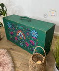 Malachite Terra Clay Paint provides endless possibilities for your imagination and can be used on wood, canvas, tile, fabric and more!
Wooden suitcase with handle facing up painted in Malachite Terra Clay Paint with distressed edges and corners, the Latin Floral Transfer is seen on the front side.