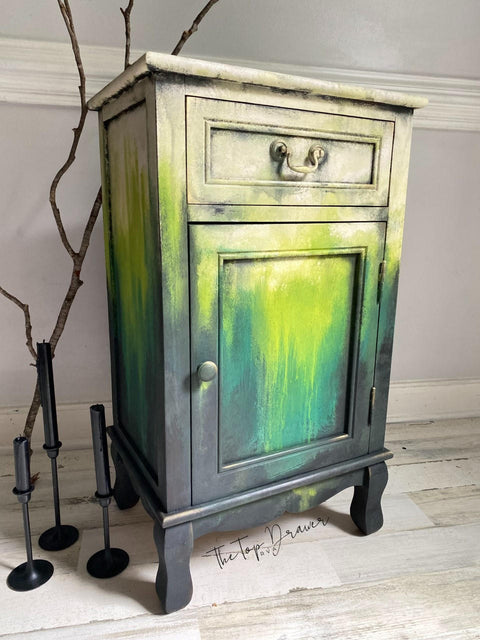 Onyx Terra Clay Paint provides endless possibilities for your imagination and can be used on wood, canvas, tile, fabric and more! Yellow, green and black clay painted end table blended together. Staged with a wood stick and black candle sticks.