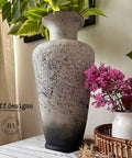Onyx Terra Clay Paint provides endless possibilities for your imagination and can be used on wood, canvas, tile, fabric and more! Textured cream vase with Black clay paint on the bottom and splattered on the vase. Staged with plants.