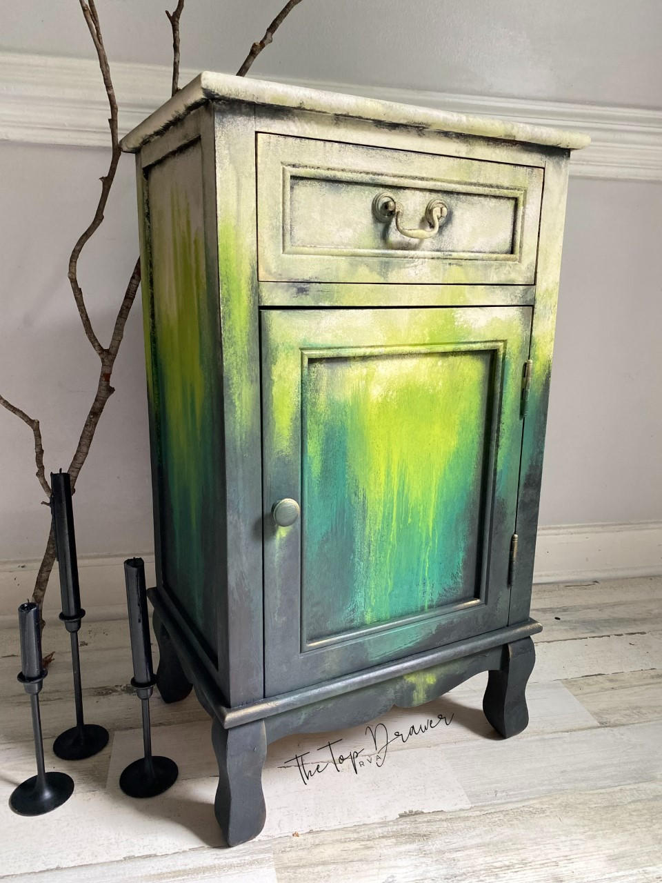 Pistachio Terra Clay Paint provides endless possibilities for your imagination and can be used on wood, canvas, tile, fabric and more! Yellow, green and black clay painted end table blended together. Staged with a wood stick and black candle sticks.