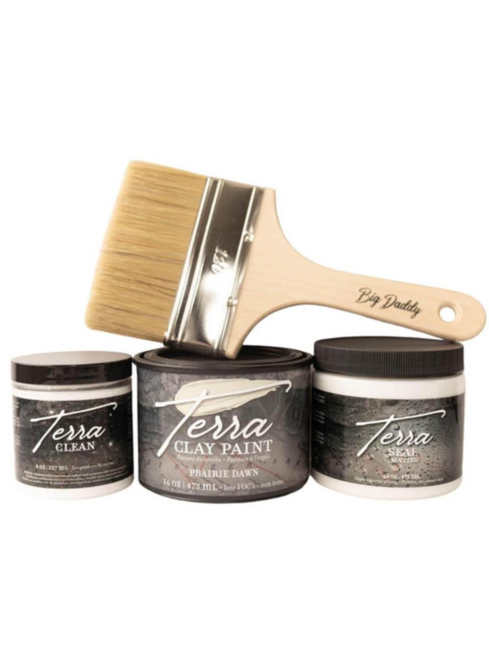 Terra Clay Paint Bundle 
Image shows, from Left to Right; an 8 ounce Terra clean, Terra Clay Paint 16 ounce in Prairie Dawn, Terra seal in a 16 ounces with a Big Daddy Brush on top of the Terra paint and the Terra seal horizontally on a white background.
