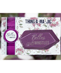 Belles and Whistles Thing-a-ma-jig - Thing-a-ma-jig in it's packaging with a purple, green and white blurred background