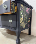 Navy blue painted dresser with the Vintage Botanical decoupage paper applied on the side and on the sides of the drawers.