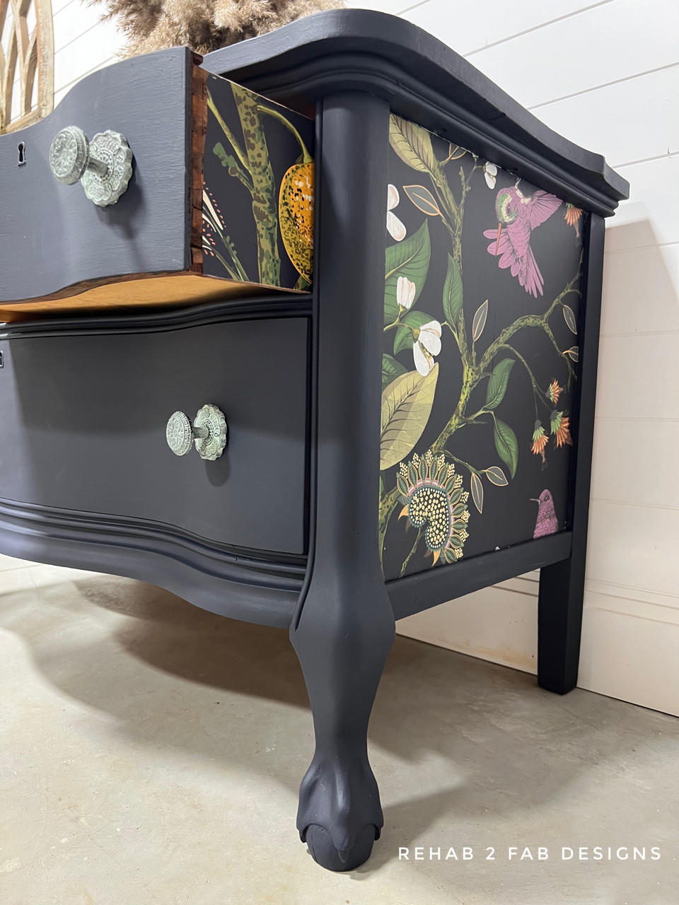 Navy blue painted dresser with the Vintage Botanical decoupage paper applied on the side and on the sides of the drawers.