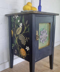 Navy blue painted nightstand with the Vintage Botanical decoupage paper applied on the side.