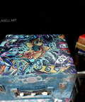 Blue painted wooden briefcase with the Vintage Tattoo decoupage paper applied on top.