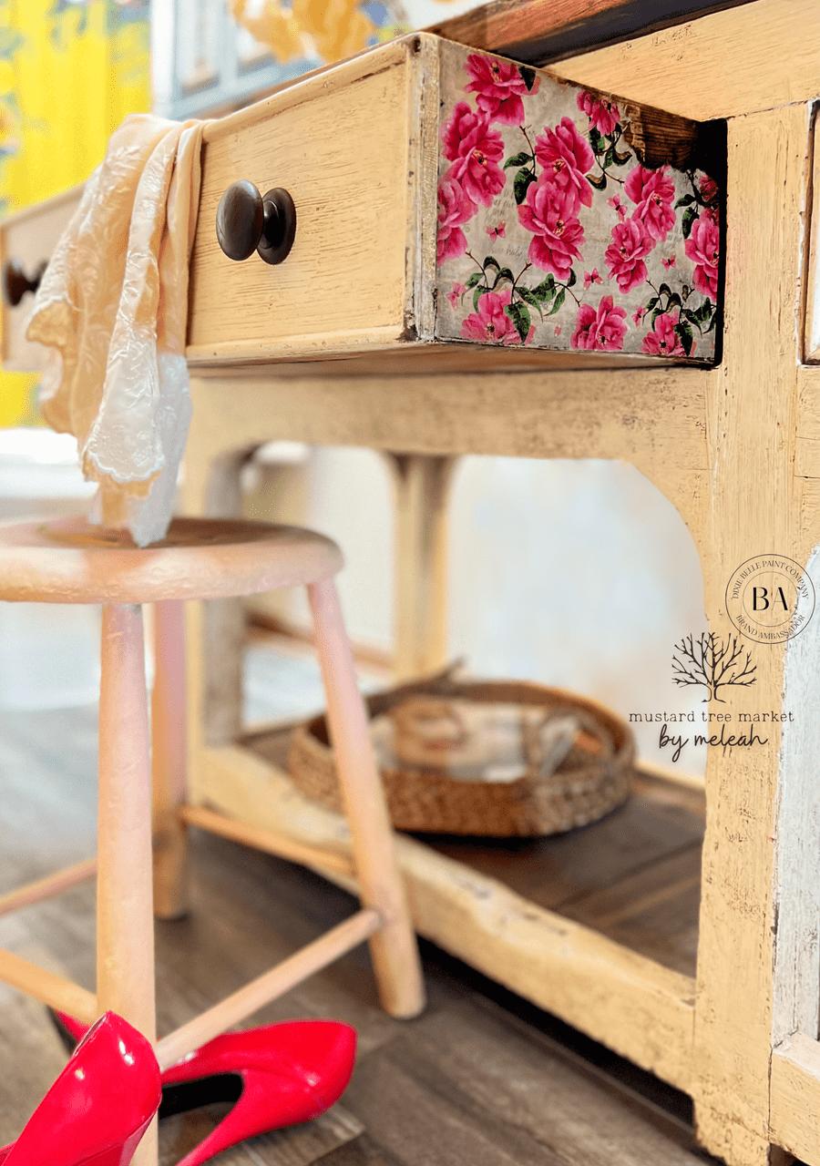 Light natural wood piece with the Vintage Wallpaper decoupage paper applied on the side of the drawer.