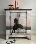 Vintage charm meets equestrian elegance: an exquisitely painted cabinet featuring the Winter Gallop A1 Rice Decoupage Paper showcasing a majestic horse, set against a serene backdrop, inviting a touch of the wild into a tranquil home setting.