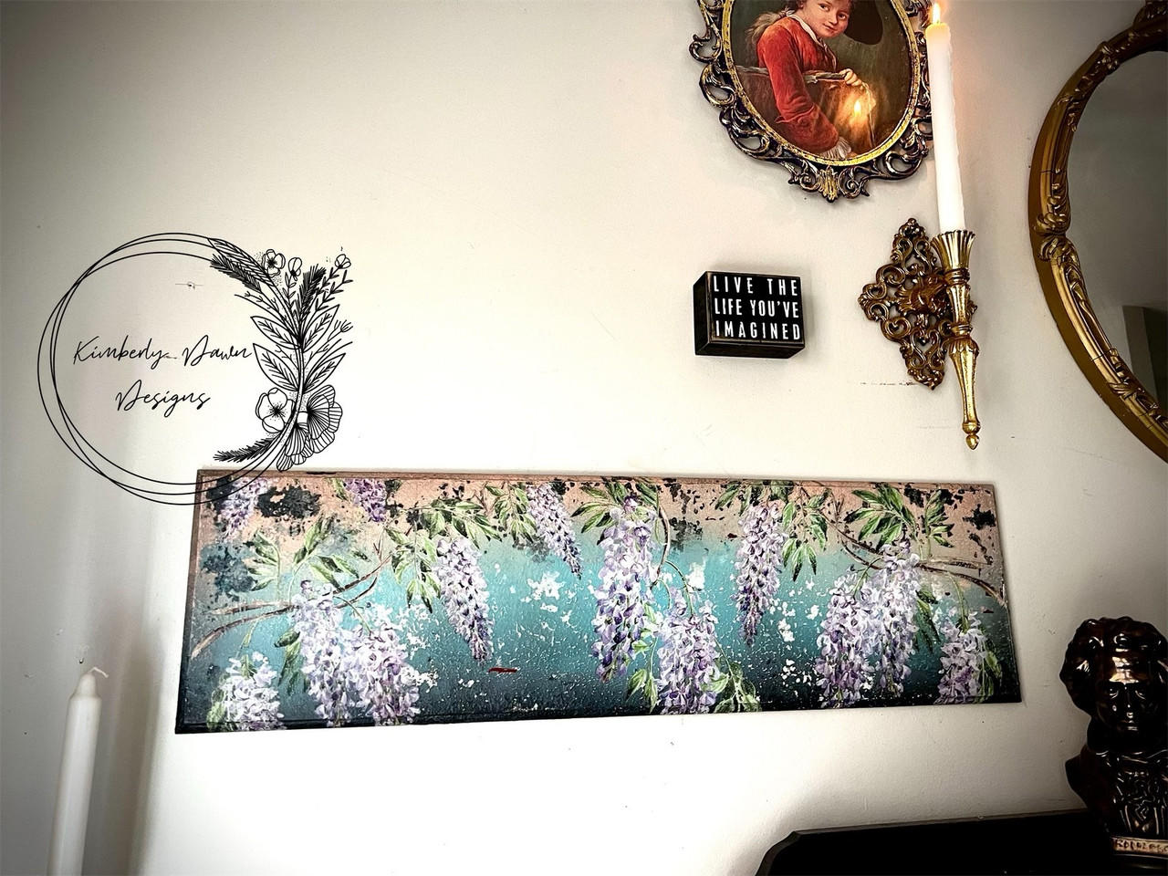 A painted panel going from dark blue gradient to light blue and light orange at the very top with Wisteria Spring Transfer applied around the piece. Staged on a wall.