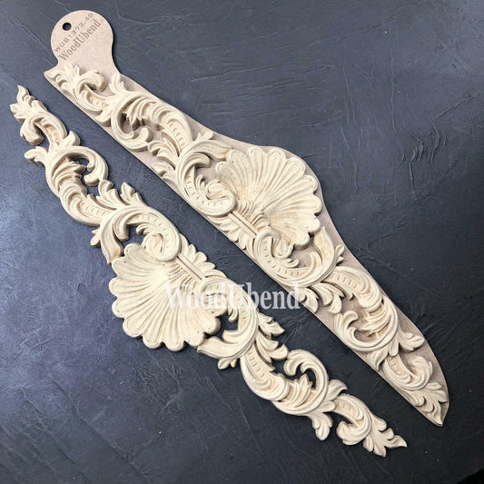 WoodUBend Applique #1372.48 (Set of 2) is the perfect mouldable embellishment for any project! This image shows Applique #1372.48 (Set of 2) in its packaging against a black background.