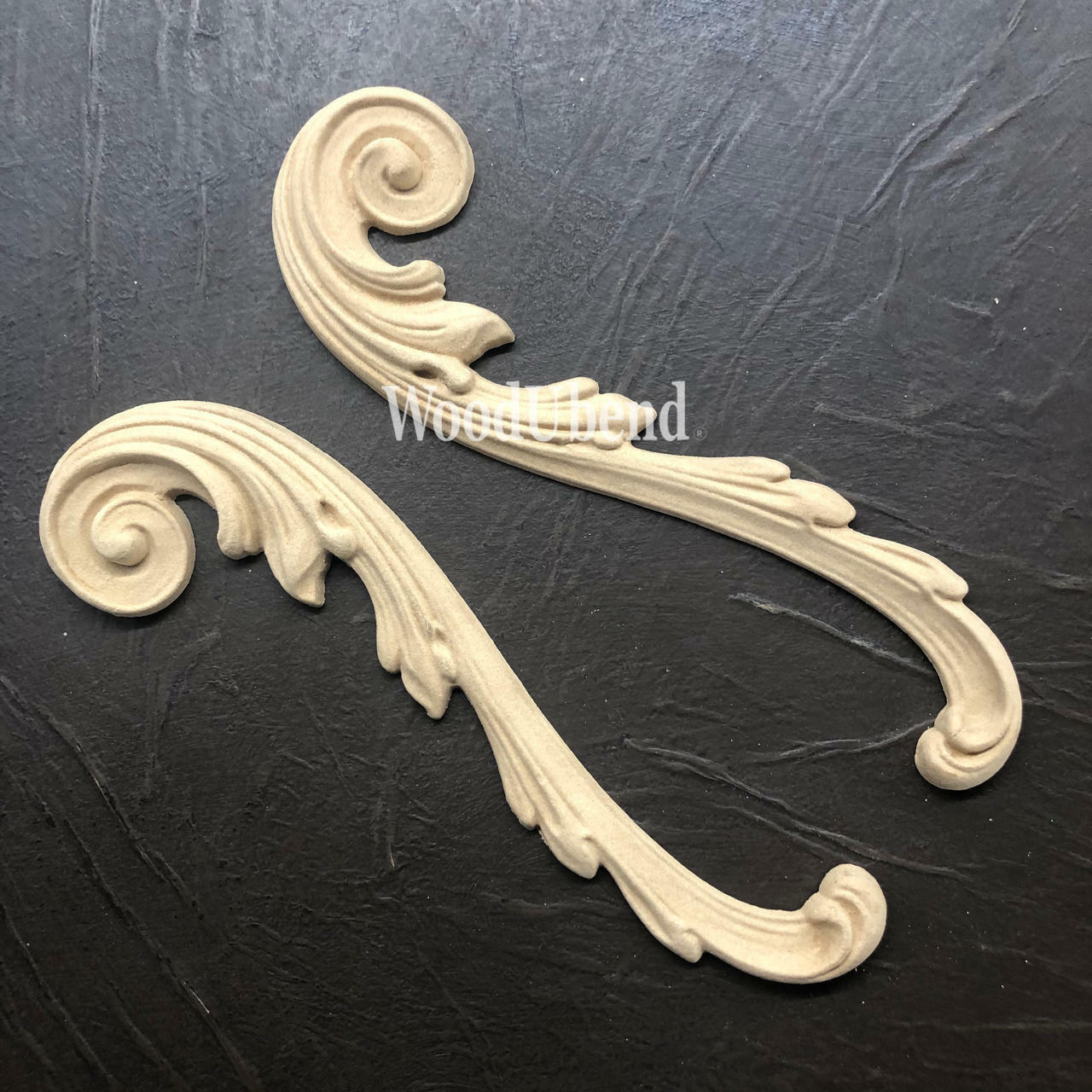 WoodUBend Applique #1723 (set of 2) is the perfect mouldable embellishment for any project!
Applique #1723 are seen both out of the packing, staged on a black crinkled background.