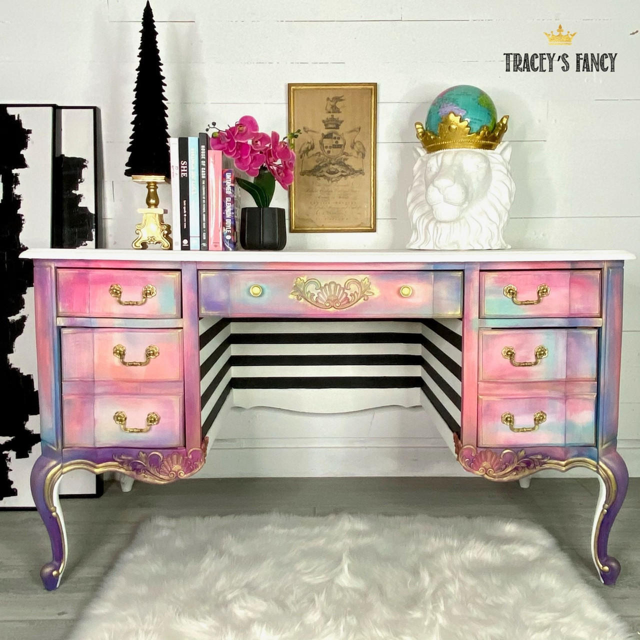 Applique #2152 Set of 2 is the perfect mouldable embellishment for any project!
A whimsical vanity with a rainbow cloudy effect, on the center drawer you can see Applique #2152 painted in gold in between the gold hardware.