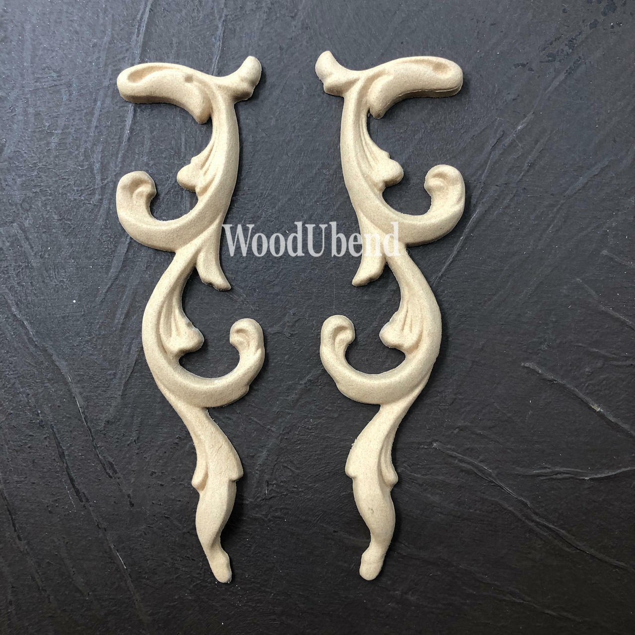 WoodUBend Applique #366-7 (set of 2) is the perfect mouldable embellishment for any project!
The Applique #366-7 (set of 2) set side by side staged on top of a black crinkled background.