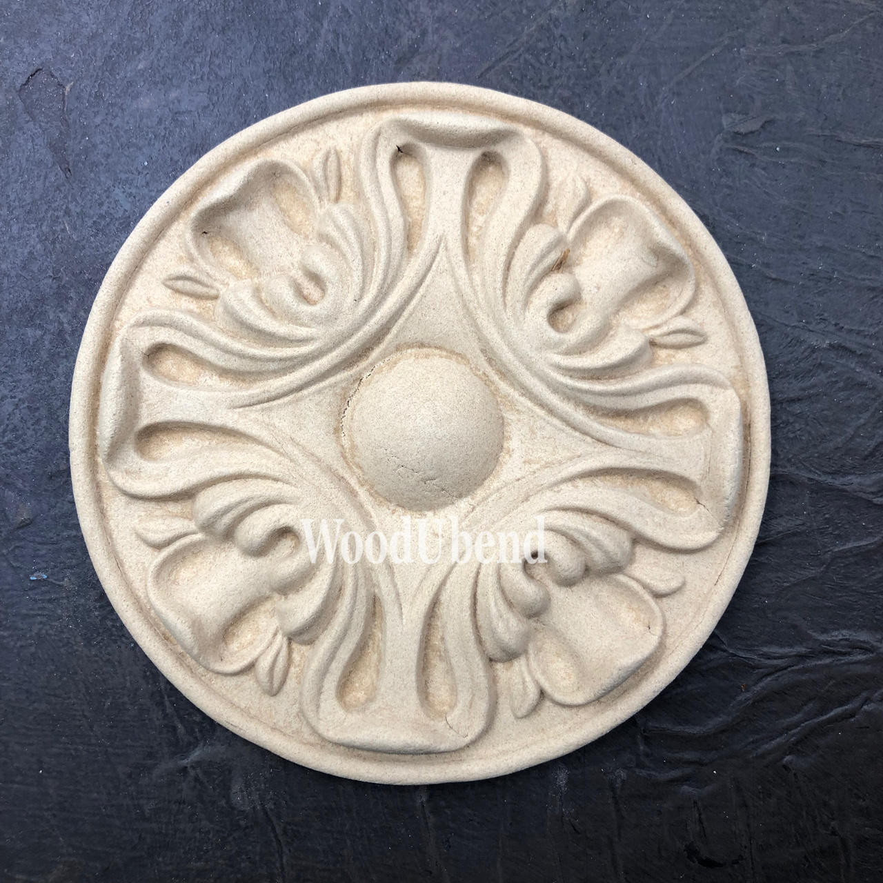 WoodUBend Applique #6013 (Set of 2) is the perfect mouldable embellishment for any project! This image shows one Applique #6013 (Set of 2) up close against a black background.