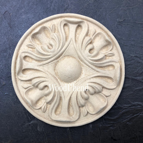 WoodUBend Applique #6013 (Set of 2) is the perfect mouldable embellishment for any project! This image shows one Applique #6013 (Set of 2) up close against a black background.