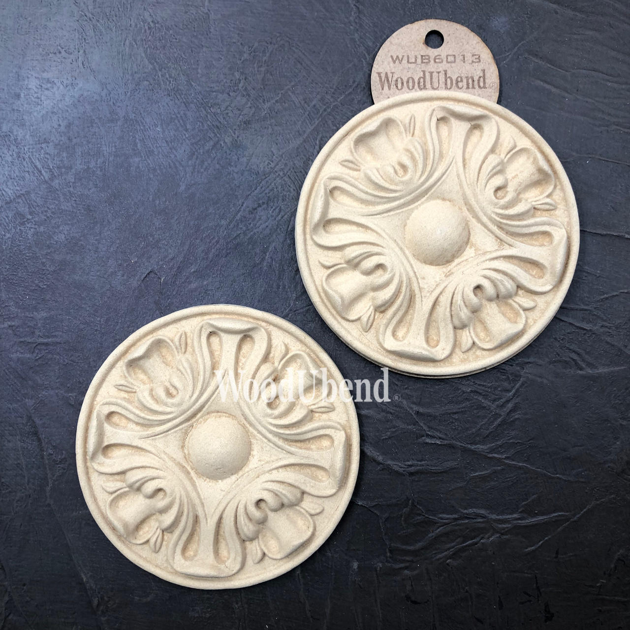 WoodUBend Applique #6013 (Set of 2) is the perfect moludable embellishment for any project! This image shows Applique #6013 (Set of 2) against a blackground with its packaging. 2 to a set.
