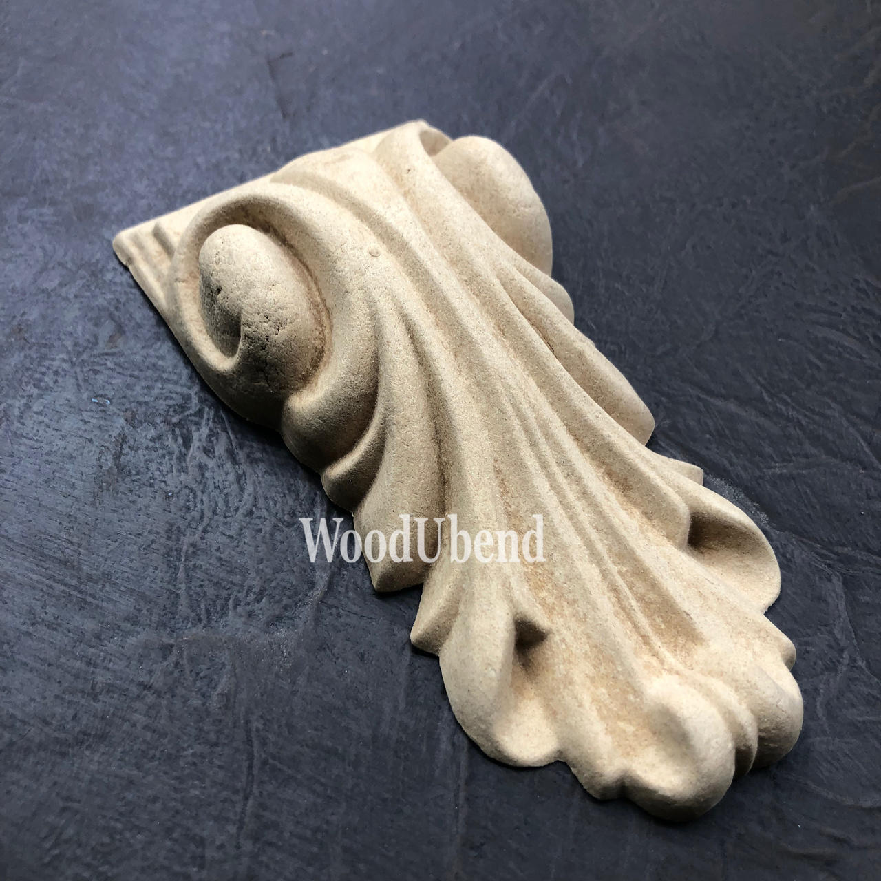 WoodUBend Applique #6022 (Set of 2) is the perfect mouldable embellishment for any project! One Applique #6022 (Set of 2) against a black background.