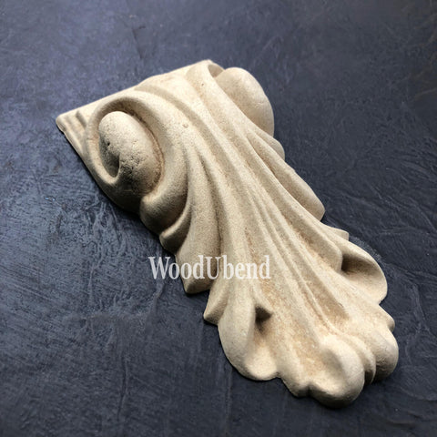 WoodUBend Applique #6022 (Set of 2) is the perfect mouldable embellishment for any project! One Applique #6022 (Set of 2) against a black background.