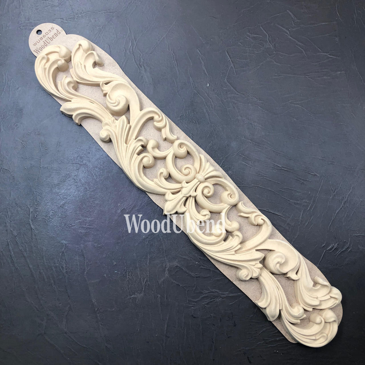 WoodUBend Applique #6035 is the perfect mouldable embellishment for any project!
Applique #6035 in its packaging against a black background.