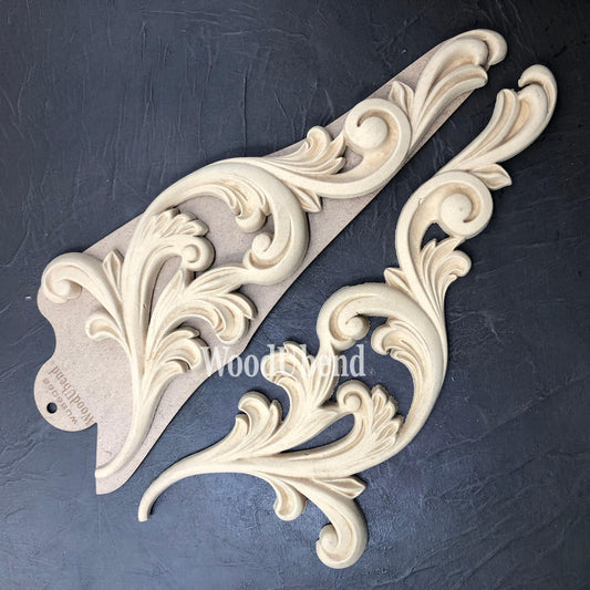 WoodUBend Applique #6068 (set of 2) is the perfect mouldable embellishment for any project! This image shows WoodUBend Applique #6068 (set of 2) with its packaging against a black background.