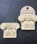 WoodUBend Applique #6079 (Set of 2) is the perfect mouldable embellishment for any project!
The Applique #6079 (Set of 2) is seen with one in a packaging and one without. Stage on top of a black crinkled background.