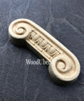 WoodUBend Applique #6081 (Set of 2) is the perfect mouldable embellishment for any project! 
One of the Applique #6081 (Set of 2) is seen flat and facing to the left. Staged on a black crinkled background.
