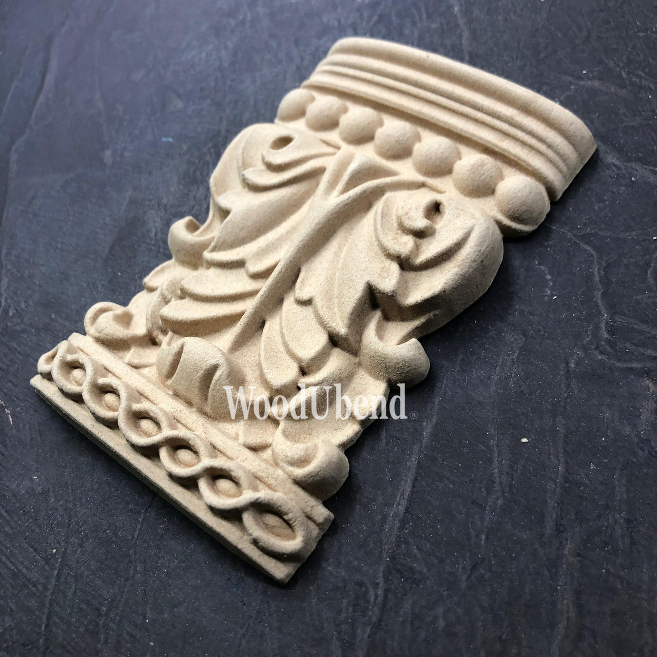 WoodUBend Applique #6088 (Set of 2) is the perfect mouldable embellishment for any project!
One Applique #6088 (Set of 2) staged diagonally on a black crinkled background.