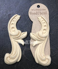 WoodUBend Applique #6096 (set of 2) is the perfect mouldable embellishment for any project!
Applique #6096 (set of 2) is seen with one in a packaging and one without. Stage on top of a black crinkled background.