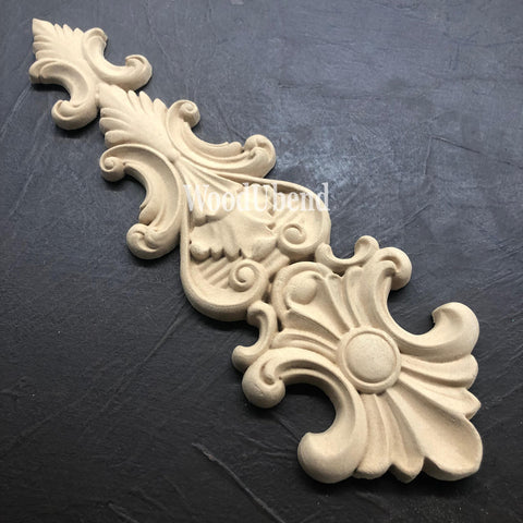 WoodUBend Applique #X1002 is the perfect moldable embellishment for any project!
The Applique #X1002 is seen displayed upside down and staged on a black crinkled background.