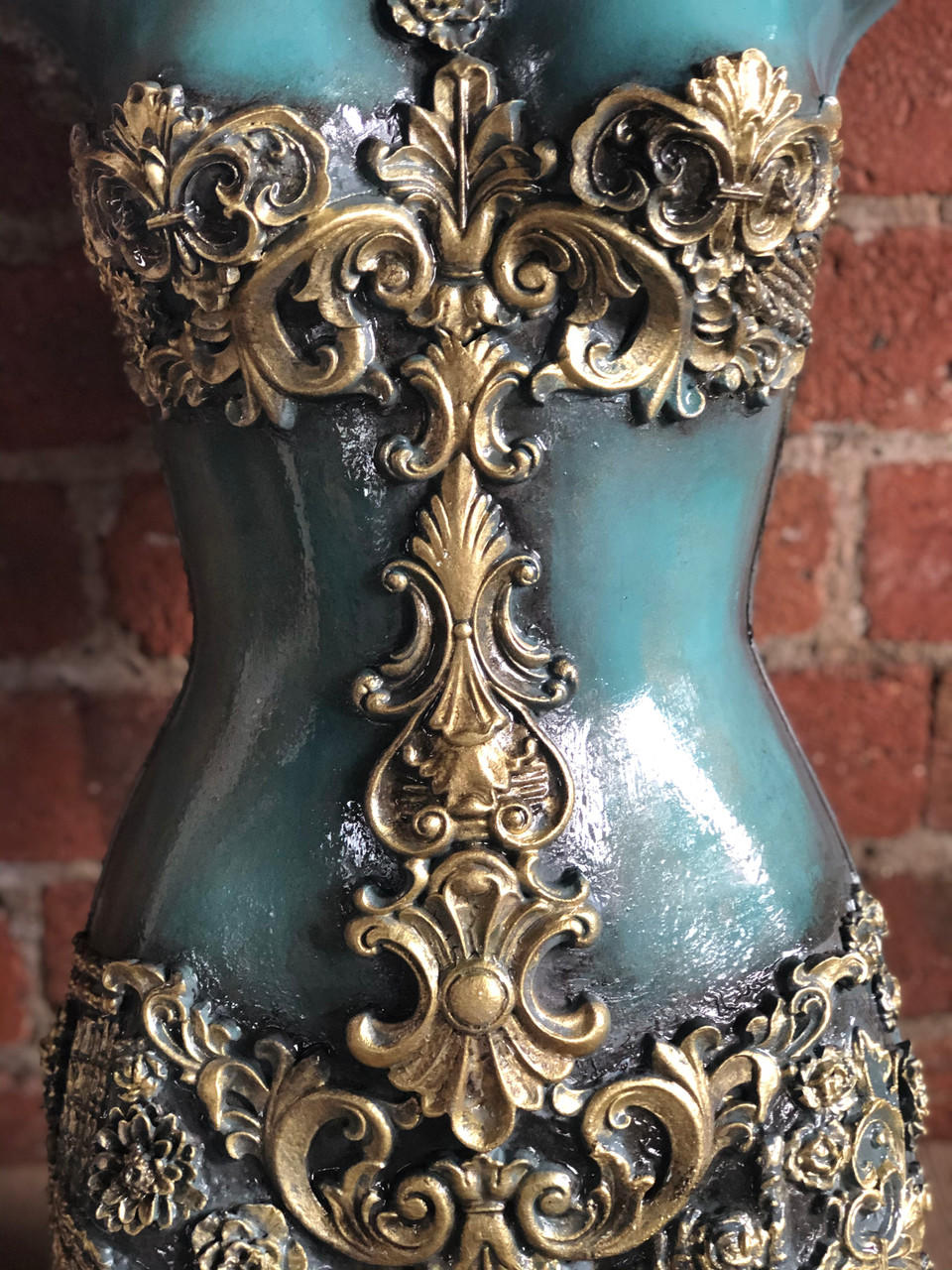 WoodUBend Applique #X1002 is the perfect moldable embellishment for any project!
A mannequin torso with the Applique #X1002 painted in a gold/bronze color going down the middle of the body, with more woodwork around the bust and on the lower half.