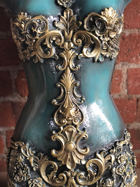 WoodUBend Applique #X1002 is the perfect moldable embellishment for any project!
A mannequin torso with the Applique #X1002 painted in a gold/bronze color going down the middle of the body, with more woodwork around the bust and on the lower half.